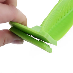 Close-up of a hand pinching the flexible green Silicone Kitchen Snap N Strain Filter to show its snap design and silicone material.