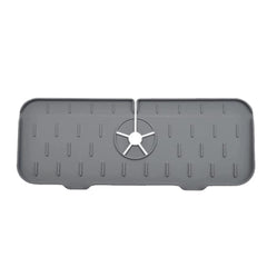 Gray rectangular Kitchen Faucet Mat with textured surface and central cutout for faucet installation.