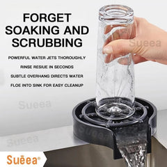 Hand holding glass rinsed with powerful water jets on Glass Rinser Automatic Cup Washer over sink for easy cleanup