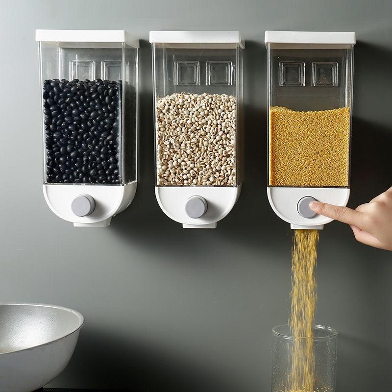 Wall-Mounted Kitchen Multi-Grain Sealed Jars dispensing grains with a hand pressing the button on the right jar.