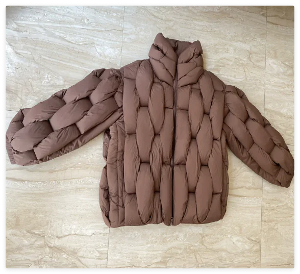 ArcticShield Men's Winter Cotton Dress Jacket in brown with unique quilted design, laid flat on a tiled floor.