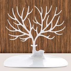 White Deer Jewelry Holder with intricate antler design on a flat base against a wooden background