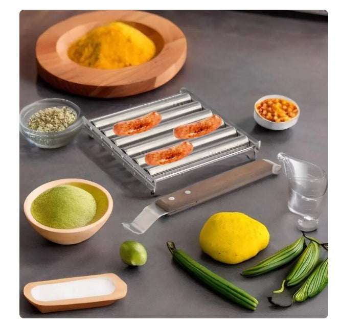 Stainless Steel Hot Dog Roller with three sausages, surrounded by spices and cooking tools on a gray surface