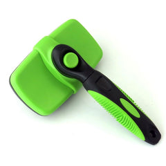Green and black plastic Self Cleaning Dog Brush with ergonomic handle and push button mechanism on white background