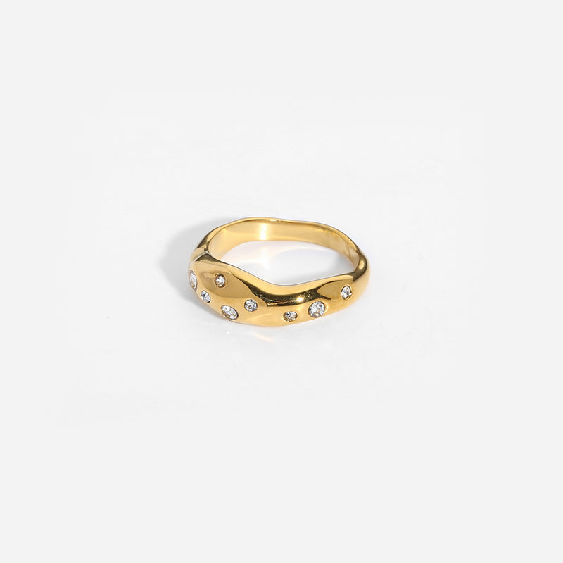 Gold Snake-Shape Ring with embedded clear gemstones on a smooth polished surface against a white background