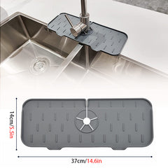 Gray Kitchen Faucet Mat placed around a modern stainless steel sink faucet to protect countertop from water spills.