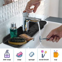 A black Kitchen Faucet Mat holding grooming items under a running faucet in a bathroom sink.