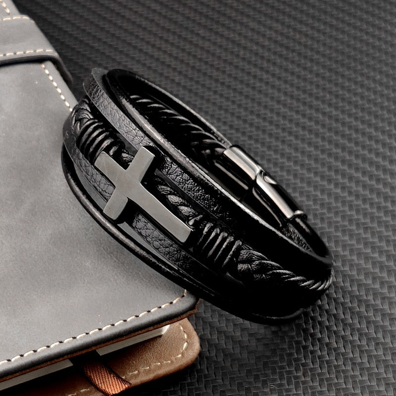 Men Chakra Bracelet featuring black leather bands with a silver cross charm and magnetic clasp on dark textured surface.