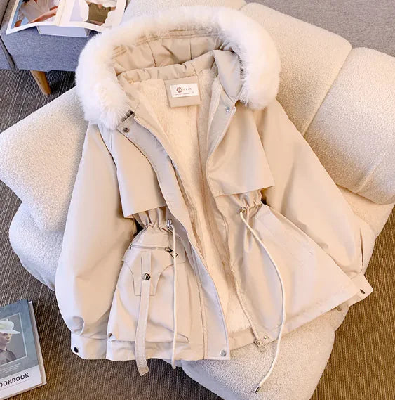 Women's Slimming Hooded Cotton-Padded Jacket in beige with fur-lined hood and adjustable waist, displayed on a chair.