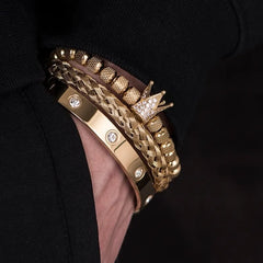 Diamond Roman Bracelets stacked on wrist featuring gold tones, braided design, and crown charm with embedded diamonds.