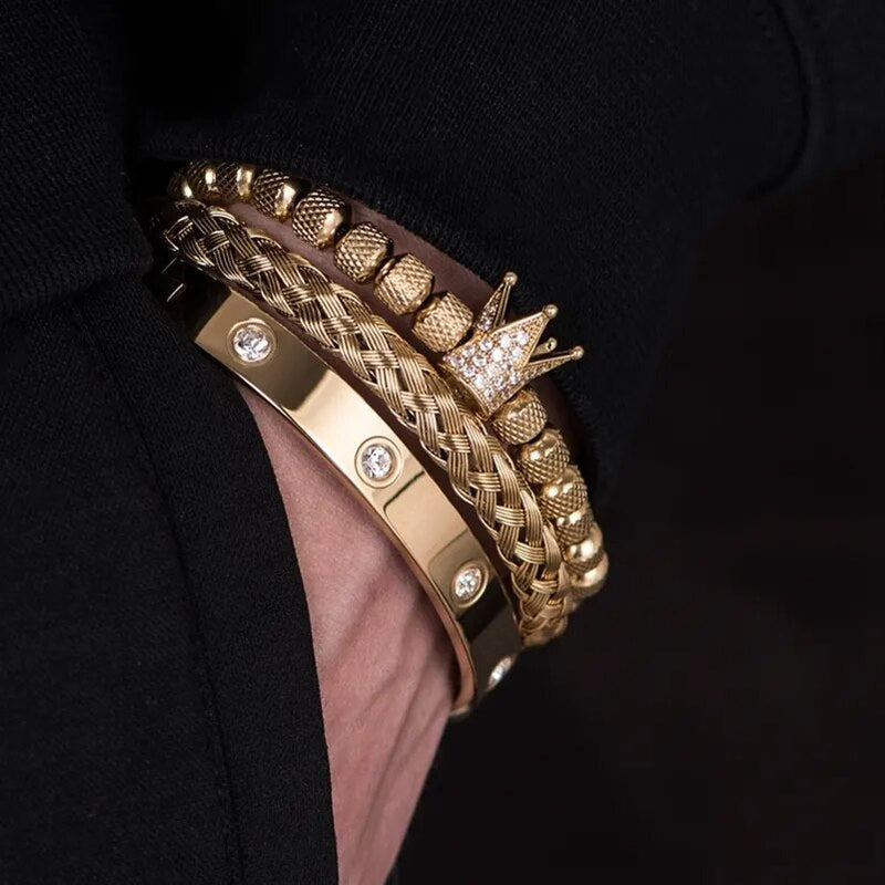 Diamond Roman Bracelets in gold with crown charm and diamond accents worn on wrist against black fabric background