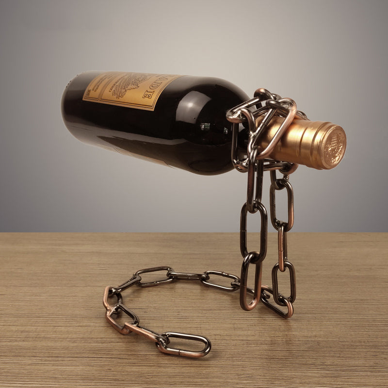 Magic Iron Chain Wine Bottle Holder suspending a wine bottle in a balanced metal chain display on wood surface