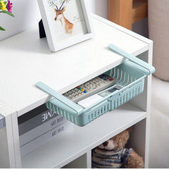 Shelf Kitchen Organizer in light blue attached under a white shelf holding remote controls and small items