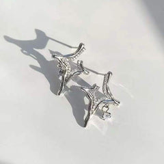 A pair of silver Asterism Rhinestone Earrings with star-shaped design and small dangling rhinestones on white background.