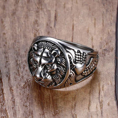Silver Lion Head Rings with detailed mane and intricate side patterns on wooden surface background