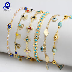 Set of six gold-tone Charm Bracelet chains adorned with blue evil eye and hamsa hand charms and beads
