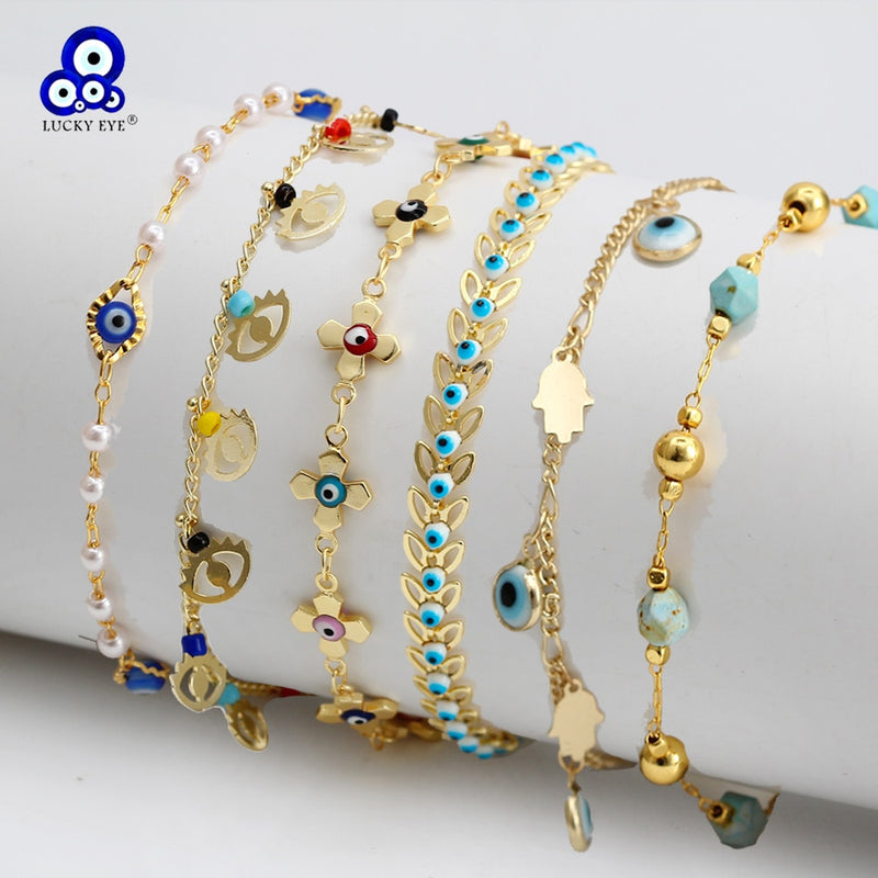 Set of six gold-tone Charm Bracelet chains adorned with blue evil eye and hamsa hand charms and beads