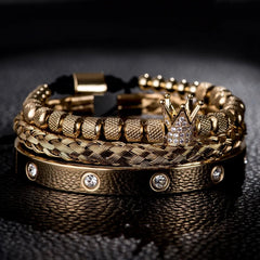 Stack of gold Diamond Roman Bracelets featuring a crown charm and sparkling embedded diamonds on textured bands