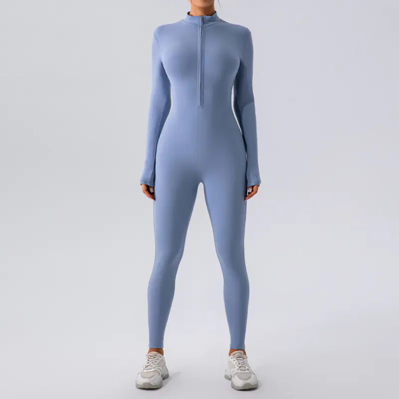 Woman wearing a light blue High Elastic Zipper Yoga Jumpsuit Women with long sleeves and white sneakers.