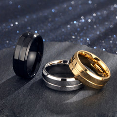 Three stylish Electroplating Rings in black, silver, and gold finishes displayed on a dark surface