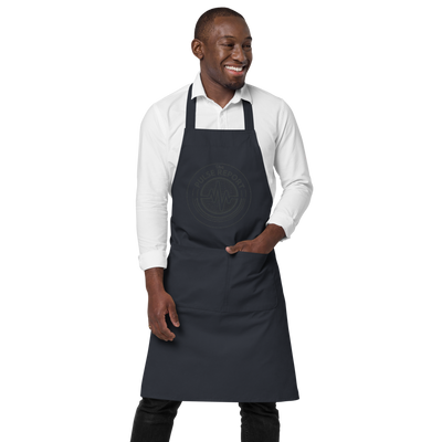Man wearing a black apron with front pockets and 
