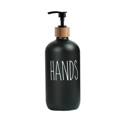 Black soap dispenser with wooden pump top labeled "HANDS" near a Kitchen Faucet Mat product display.