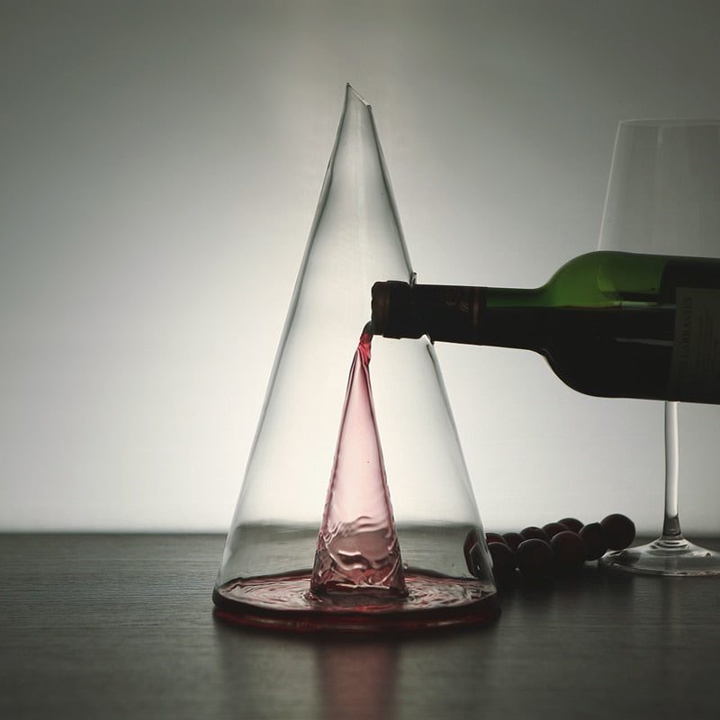 Transparent Wine Decanter with red wine being poured, highlighting its unique cone-shaped aeration design on a dark surface.