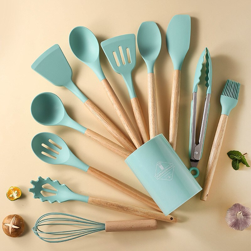 Set of turquoise kitchen utensils with wooden handles including Non Stick Pot Spatula And Spoon in a matching holder
