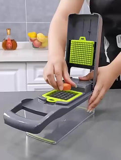 Person using a Vegetable Chopper Kitchen to dice a carrot on a gray kitchen countertop.