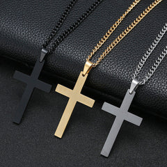 Three Cross Necklace pendants in black, gold, and silver tones on matching chains displayed on a black textured surface