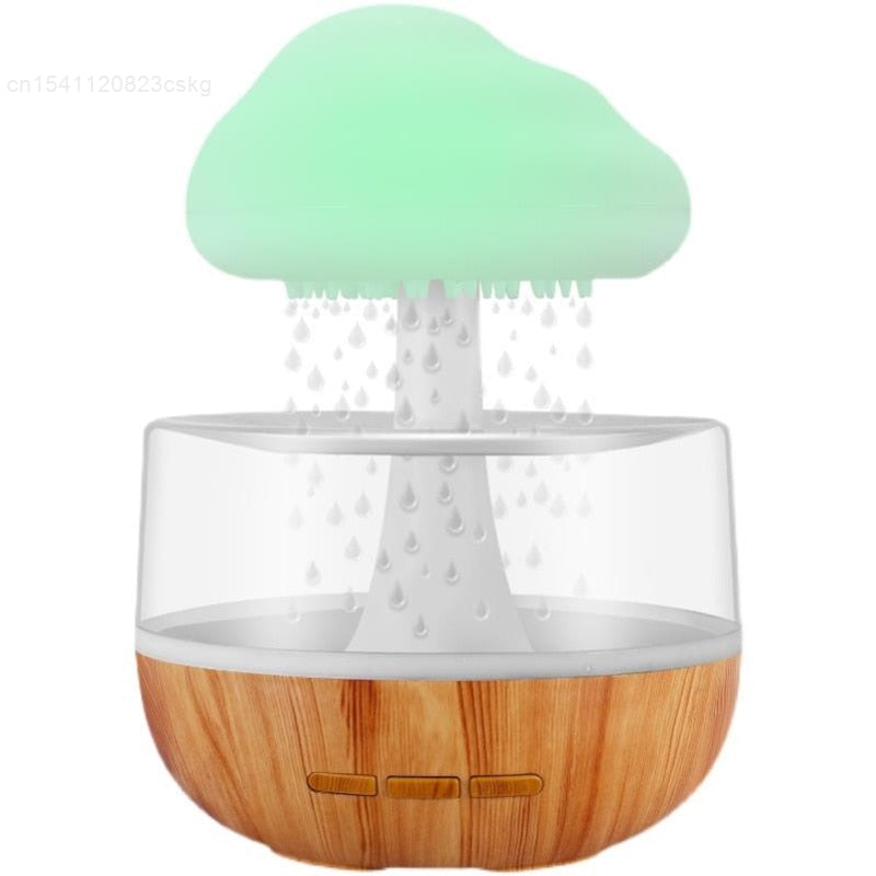 Desktop Rain Cloud Humidifier with wooden base and glowing green cloud releasing mist droplets inside clear water tank.