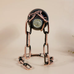 Magic Iron Chain Wine Bottle Holder shaped like a person holding a wine bottle in black and bronze tones