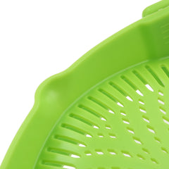 Close-up of a green Silicone Kitchen Snap N Strain Filter showing its flexible perforated surface and snap edge design.