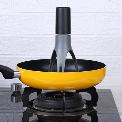 3 Speed Gear Automatic Egg Beaters standing inside a yellow frying pan on a gas stove burner.