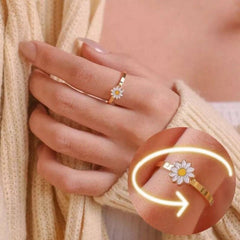 Close-up of a daisy design Fidget Spinner Rotatable Ring For Women worn on a hand with light skin tone and beige sweater.