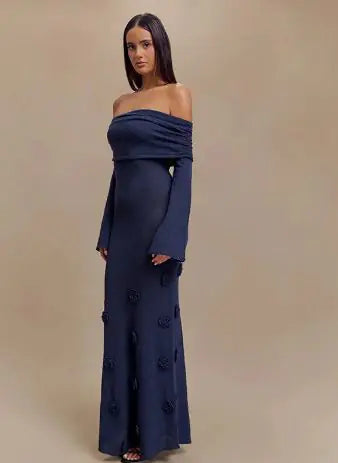 Woman wearing a navy Off Shoulder Knit Rose Maxi Dress with long sleeves and rose knit details on the skirt