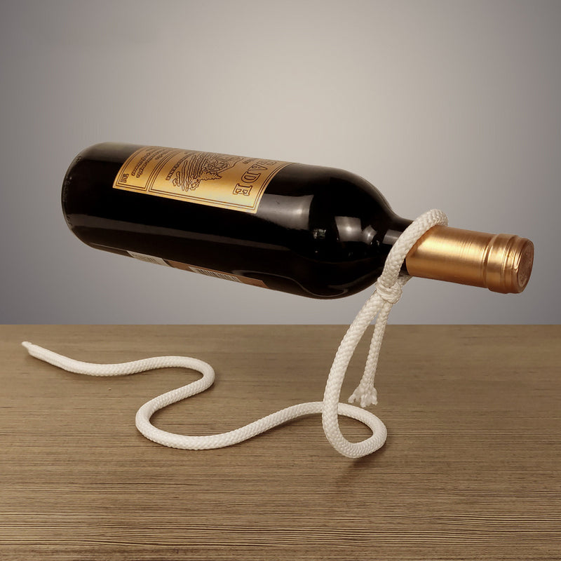 Suspended Rope Wine Bottle showing a wine bottle balanced horizontally by a white rope on a wooden surface.