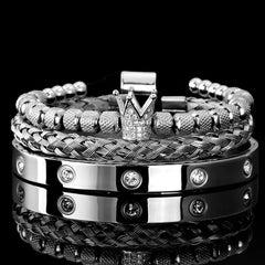 Stacked silver bracelets including a polished band with diamonds and braided details, featuring Diamond Roman Bracelets.