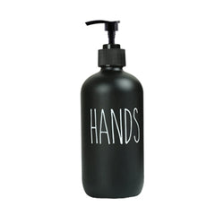 Black pump dispenser bottle labeled HANDS next to a Kitchen Faucet Mat in a clean kitchen setting